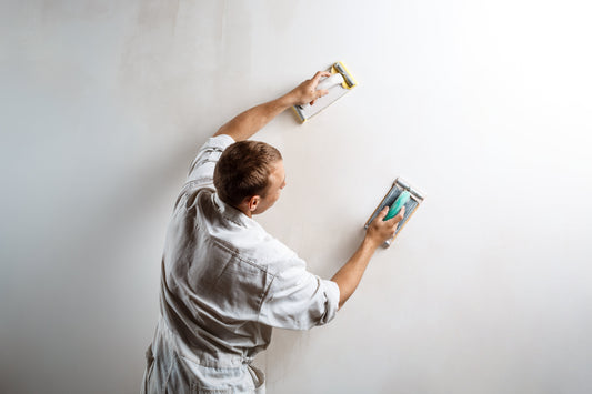 Alt image : **Plaquiste réalisant le lissage et les finitions d’un mur en plaque de plâtre avant peinture**